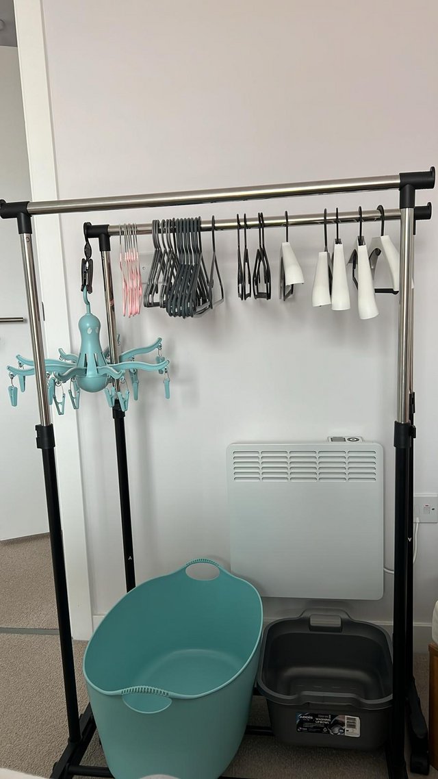 Preview of the first image of Two garment rails with 60 hangers, together with 2 buckets,.