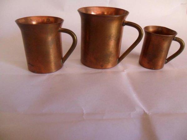 Image 2 of Three minature copper mugs with coins for their bases