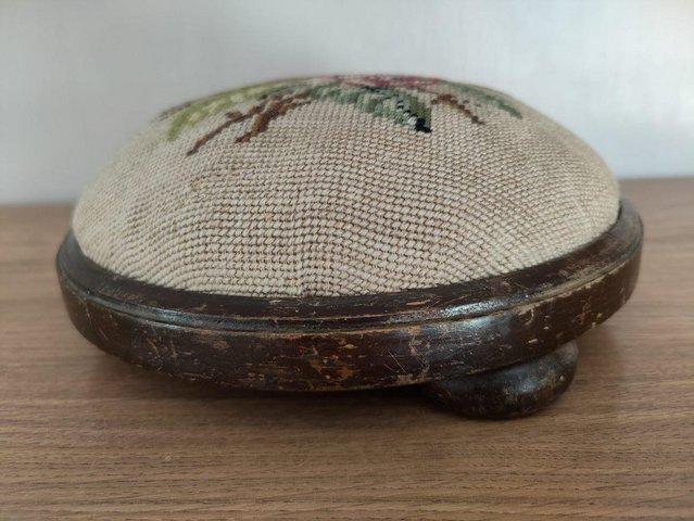 Preview of the first image of Antique small embroidered circular footstool..