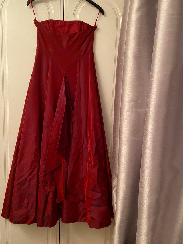 Preview of the first image of Ball Gown in burgundy colour with netted lining.