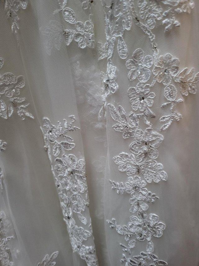 Preview of the first image of Brand new wedding dress size 10 ivory.