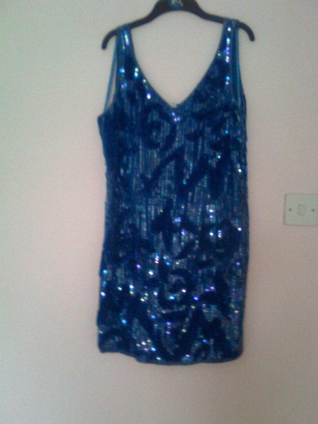 Preview of the first image of Peacock blue sequinned dress.