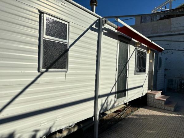 Image 6 of RS 1736 mobile home with communal pool and bar on site