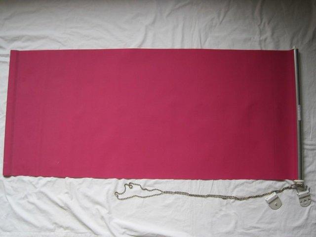 Preview of the first image of Pink roller blind with fixings.