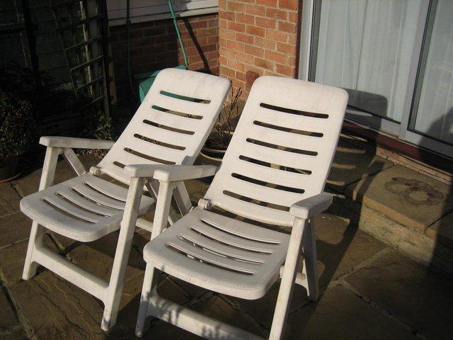 Preview of the first image of reclining garden chairs, quite large and white coloured..
