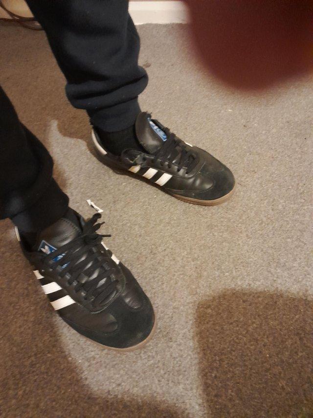 Preview of the first image of Poor condition trainers adidas size 11 black n white.