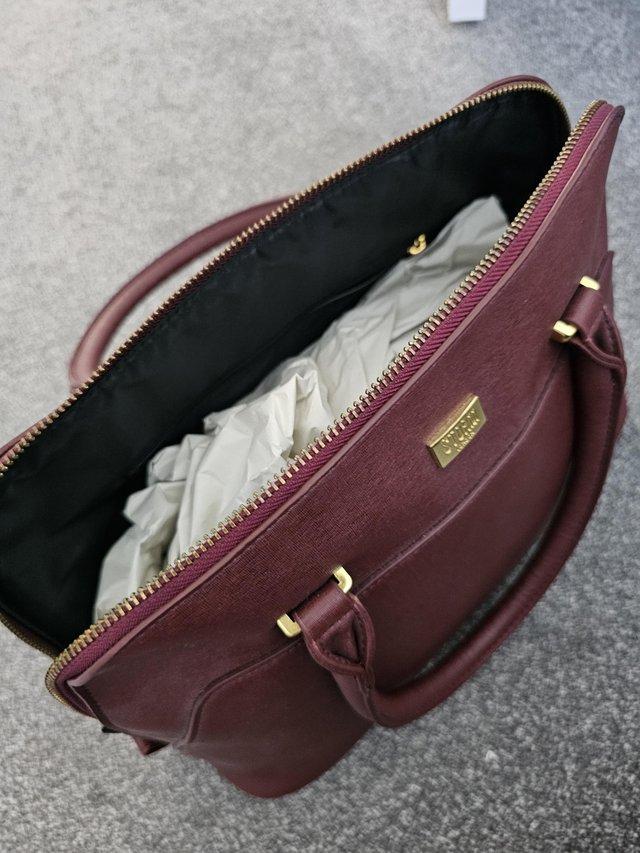 Preview of the first image of Storm Bag in burgundy as new.
