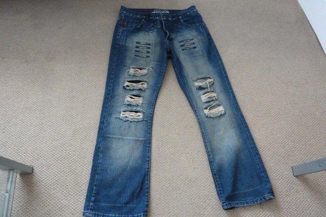 Preview of the first image of Men's "Blue Inc" ripped designer jeans.