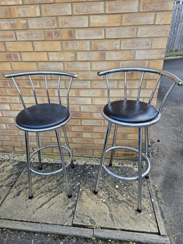 Preview of the first image of Two steel and black leather bar stools.