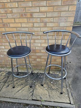 Image 1 of Two steel and black leather bar stools