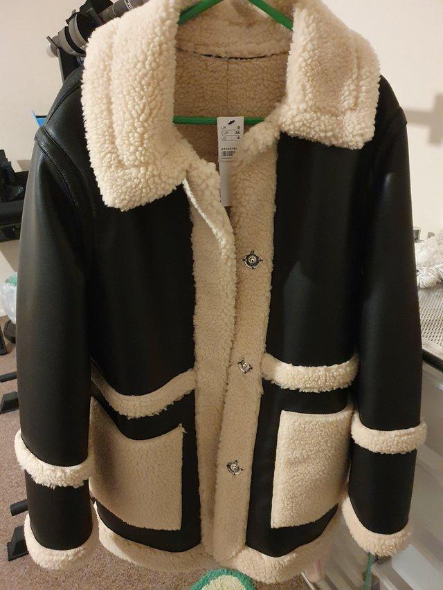 Preview of the first image of Topshop reversible borg/leather coat.