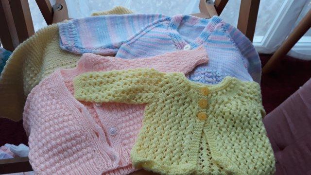 Preview of the first image of 14 new Hand knitted baby cardigans.