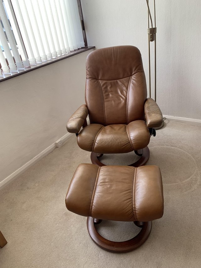 Preview of the first image of Stressless tan leather recliner chair and stool.