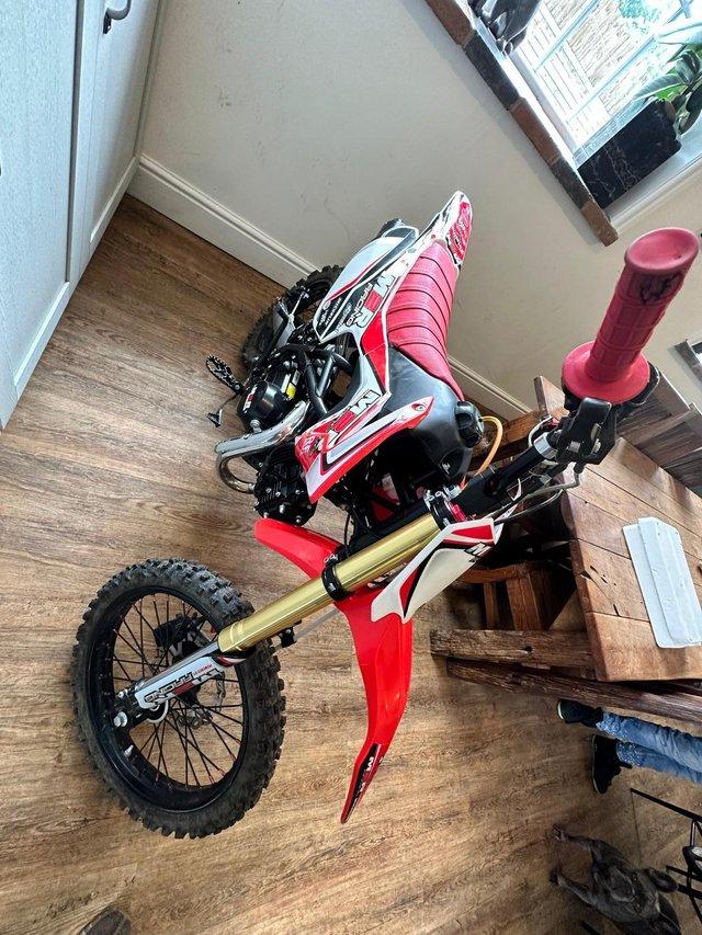Preview of the first image of M2R Racing 125cc 2023 used three timesred white and black.