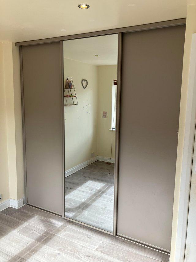 Preview of the first image of Set of three sliding doors with full height mirrored door.