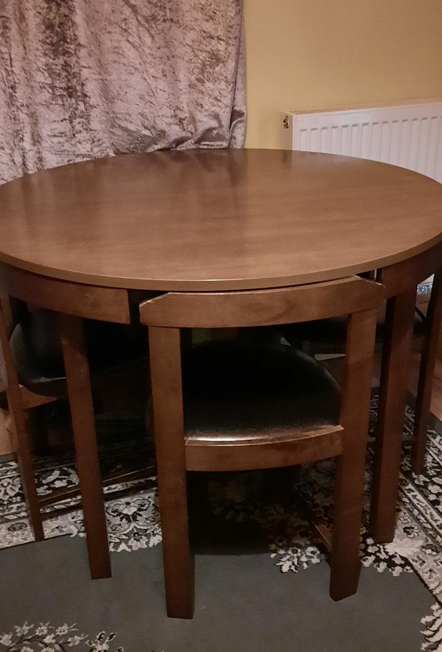 Preview of the first image of Round dining table and four chairs.