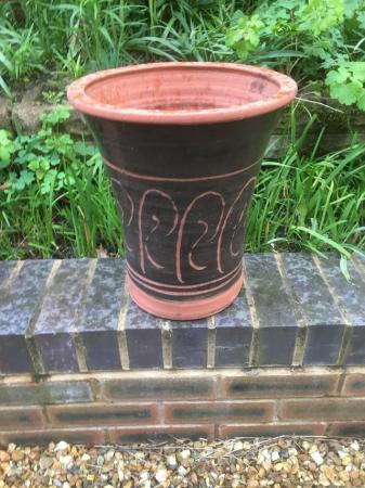 Image 2 of A tall and attractively shaped terracotta plant pot.