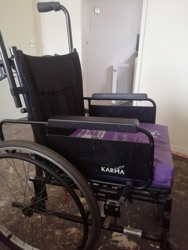 Preview of the first image of KARMA MANUAL WHEELCHAIR WITH 4 HANDLES GOOD WORKING CONDITIO.
