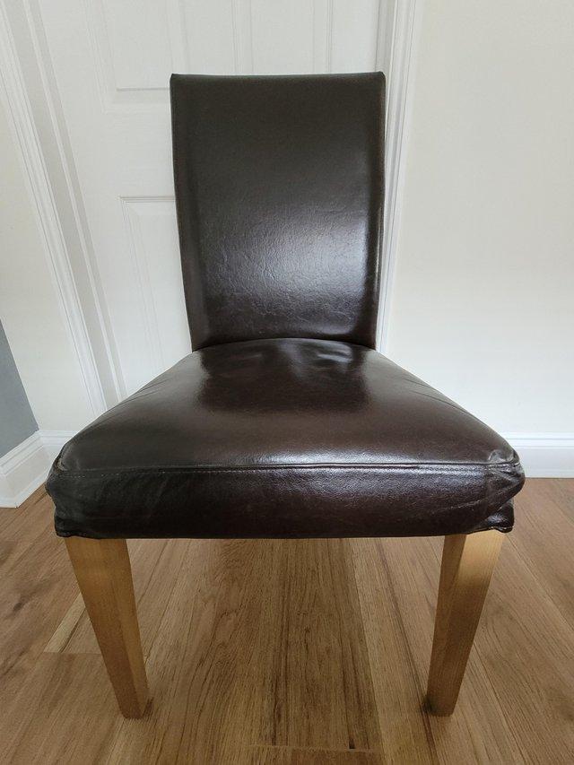 Preview of the first image of 4 IKEA Brown leather Oak dinning chairs with extra grey cove.