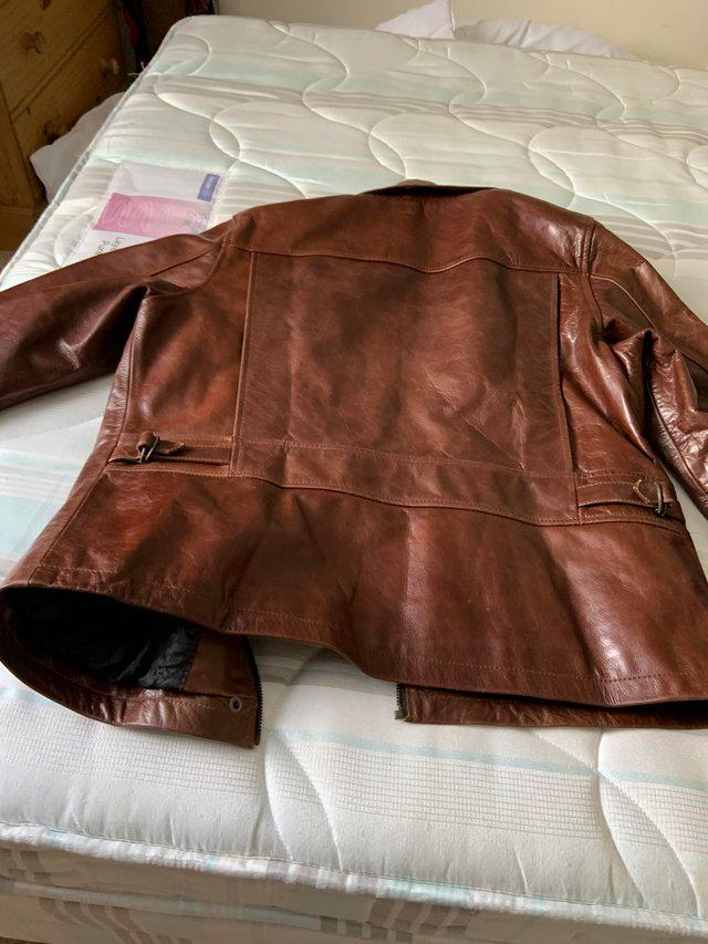 Preview of the first image of Brown leather jacket never worn.