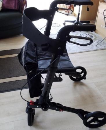 Image 1 of 4 wheeled rollator, good condition.