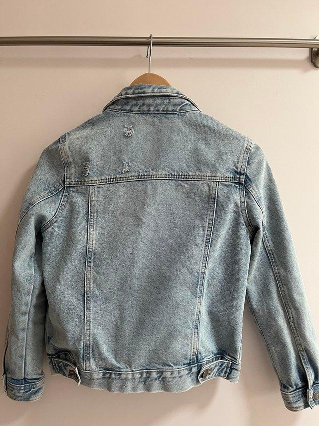 Preview of the first image of Girls Age 10-11 blue denim jacket.