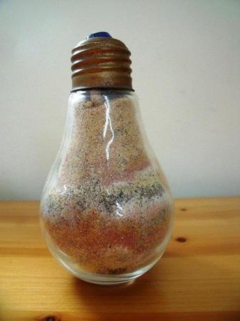 Image 2 of 2 ornaments: sand filled light bulb shape and glitter globe