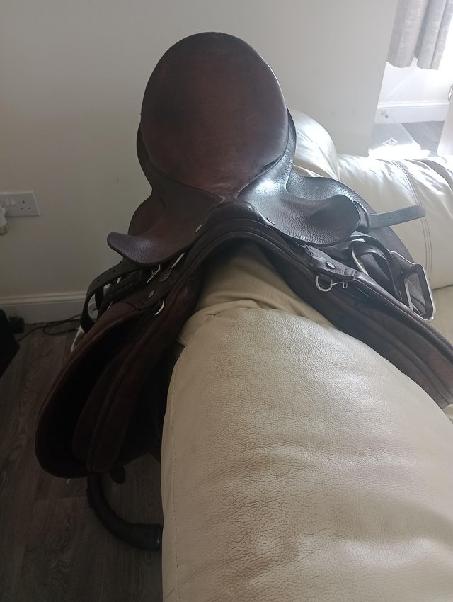 Preview of the first image of 17" wide brown leather saddle.