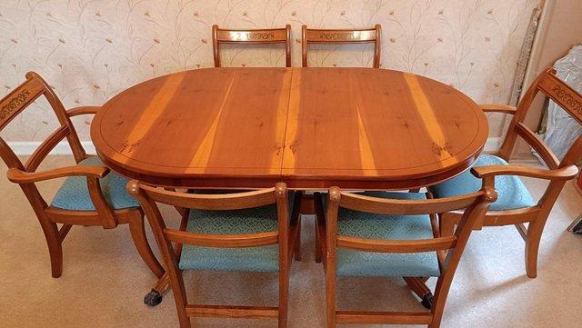 Preview of the first image of Magnificent yew wood table and six chairs.