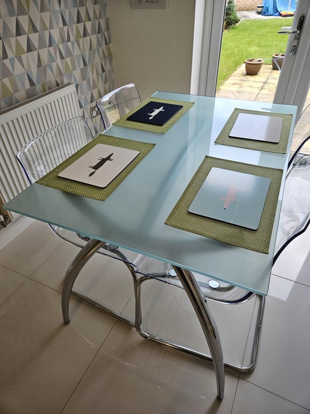 Preview of the first image of Toughened Glass Designer Dining table with chairs.