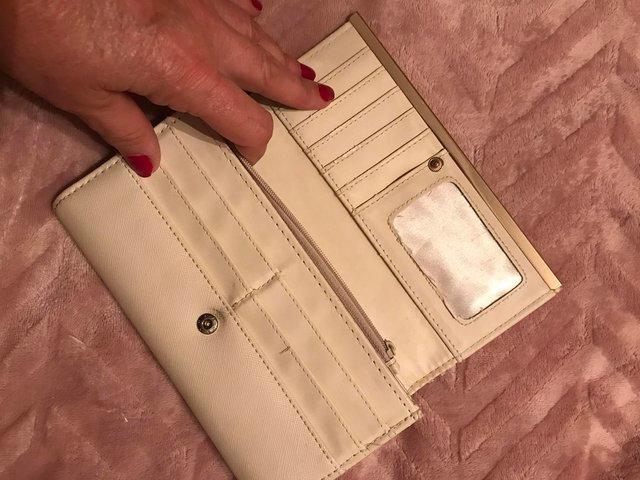 Preview of the first image of River island purse in the colour cream.
