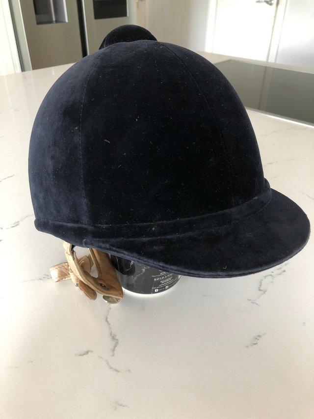 Preview of the first image of Charles Owen child’s show hat with leather fastening.