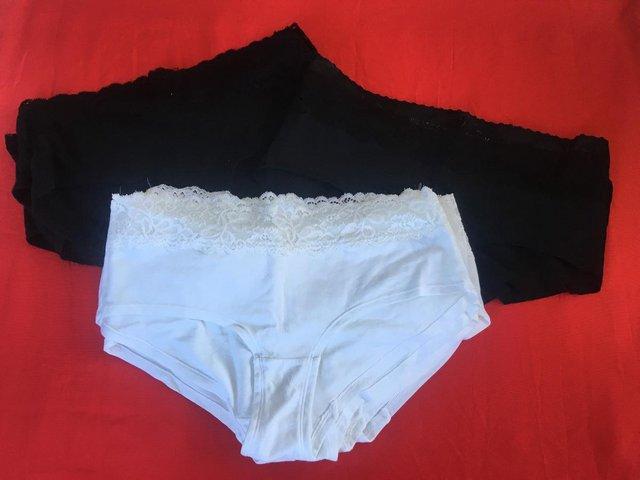 Preview of the first image of Unused 16 prs womens' M&S briefs. Black/white. Size 12 & 14.