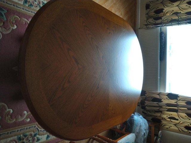 Preview of the first image of Stokers solid oak table beautiful condition.