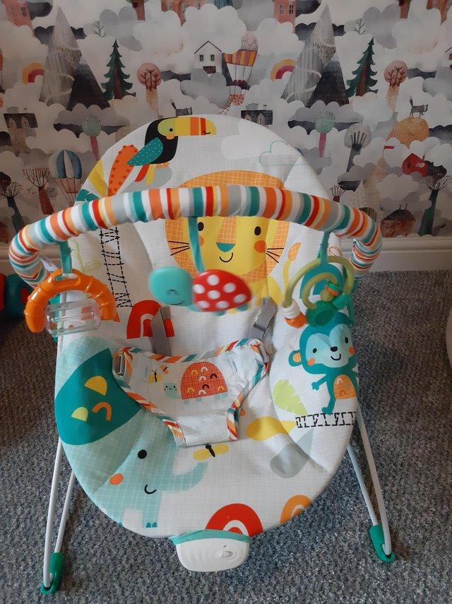 Preview of the first image of Colourful vibrating baby bouncer.