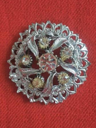 Image 1 of Pretty vintage silvertone and clear stones circular brooch.