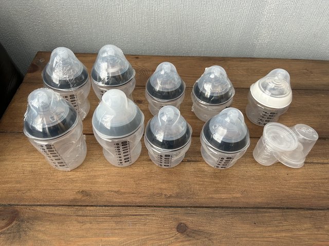 Preview of the first image of Tommee Tippee bottles and storage tub.