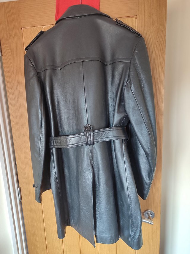 Preview of the first image of Man's belted black leather overcoat.