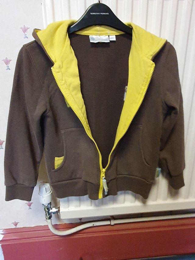 Preview of the first image of Girls Brownie uniform yellow and brown hoodie.