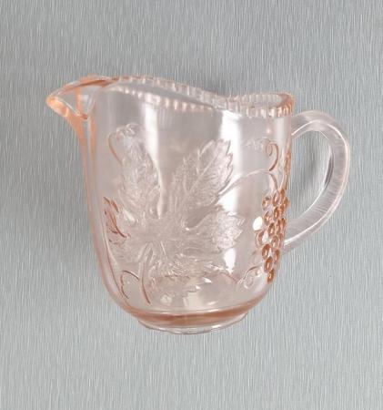 Image 1 of A Small Vintage Glass Jug with Orange Hues.  Height 3.1/2".