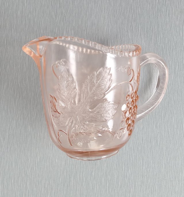 Preview of the first image of A Small Vintage Glass Jug with Orange Hues.  Height 3.1/2"..