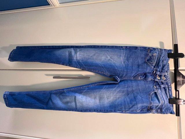 Preview of the first image of Blue washed skinny denim mid waisted jeans size 8.