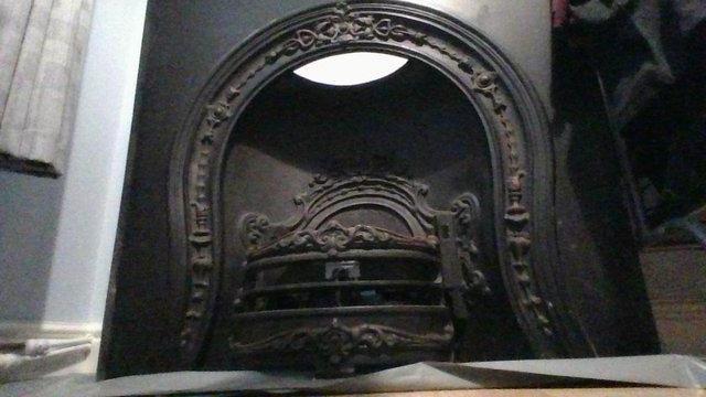 Image 2 of Horseshoe cast iron fireplace.