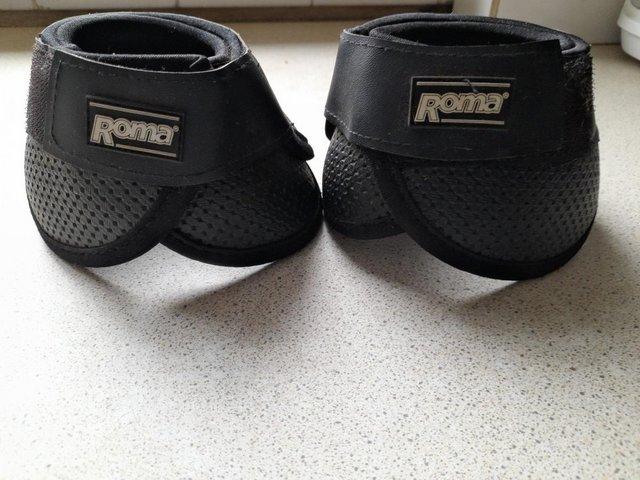 Preview of the first image of Pony size Roma Black Over Reach Boots Unused.