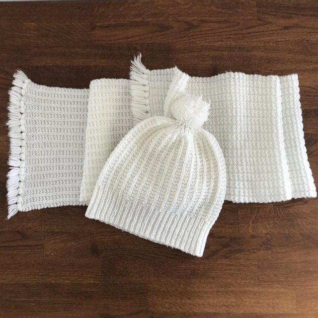 Preview of the first image of Vintage 1980's hand-knitted child's white scarf & bobble hat.