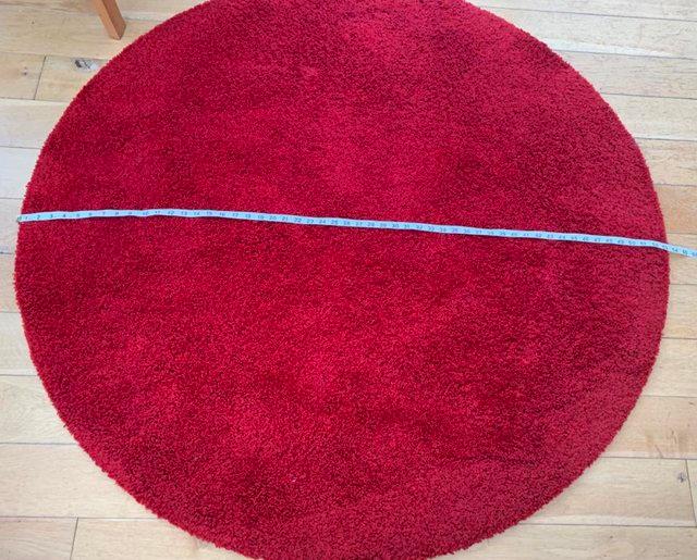 Preview of the first image of Round IKEA Red rug, in good condition.