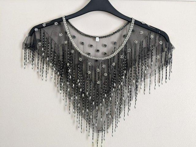 Preview of the first image of Black beaded fancy poncho, as new.