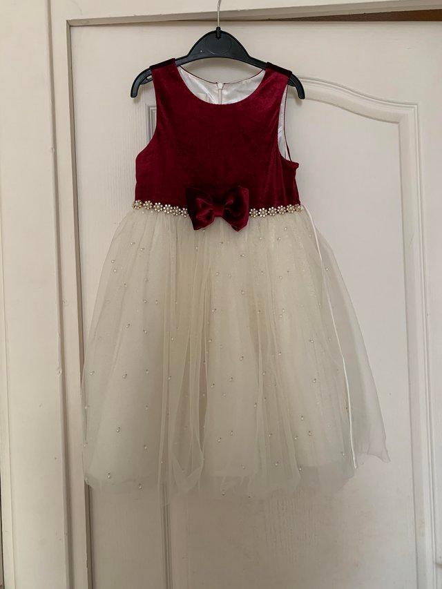 Preview of the first image of Child’s Party Dress, Wine top with cream attached skirt.