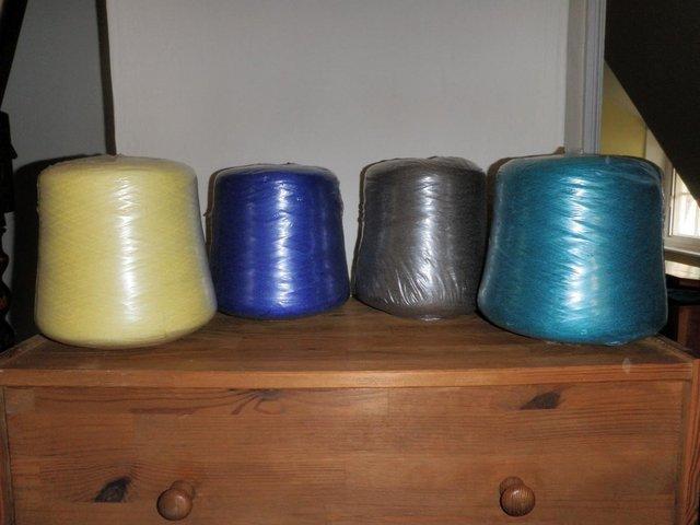 Preview of the first image of Four CONES of YARN,new in outer wrapper.