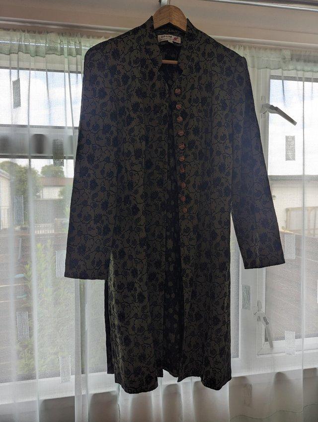 Preview of the first image of Ladies green midi length vintage coat.